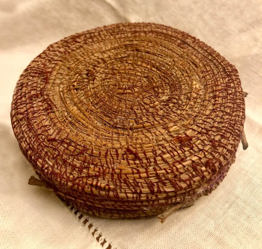 Photo of a hand-woven pine needle basket that Emmaline gifted to Patti.