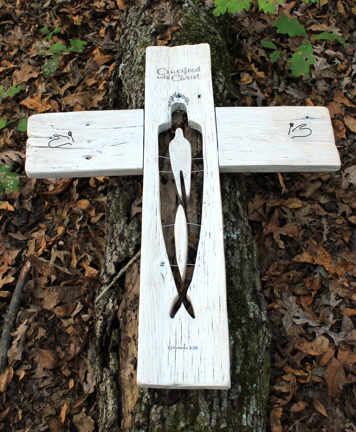 One of the "In Christ" sculptures set on an old oak log.