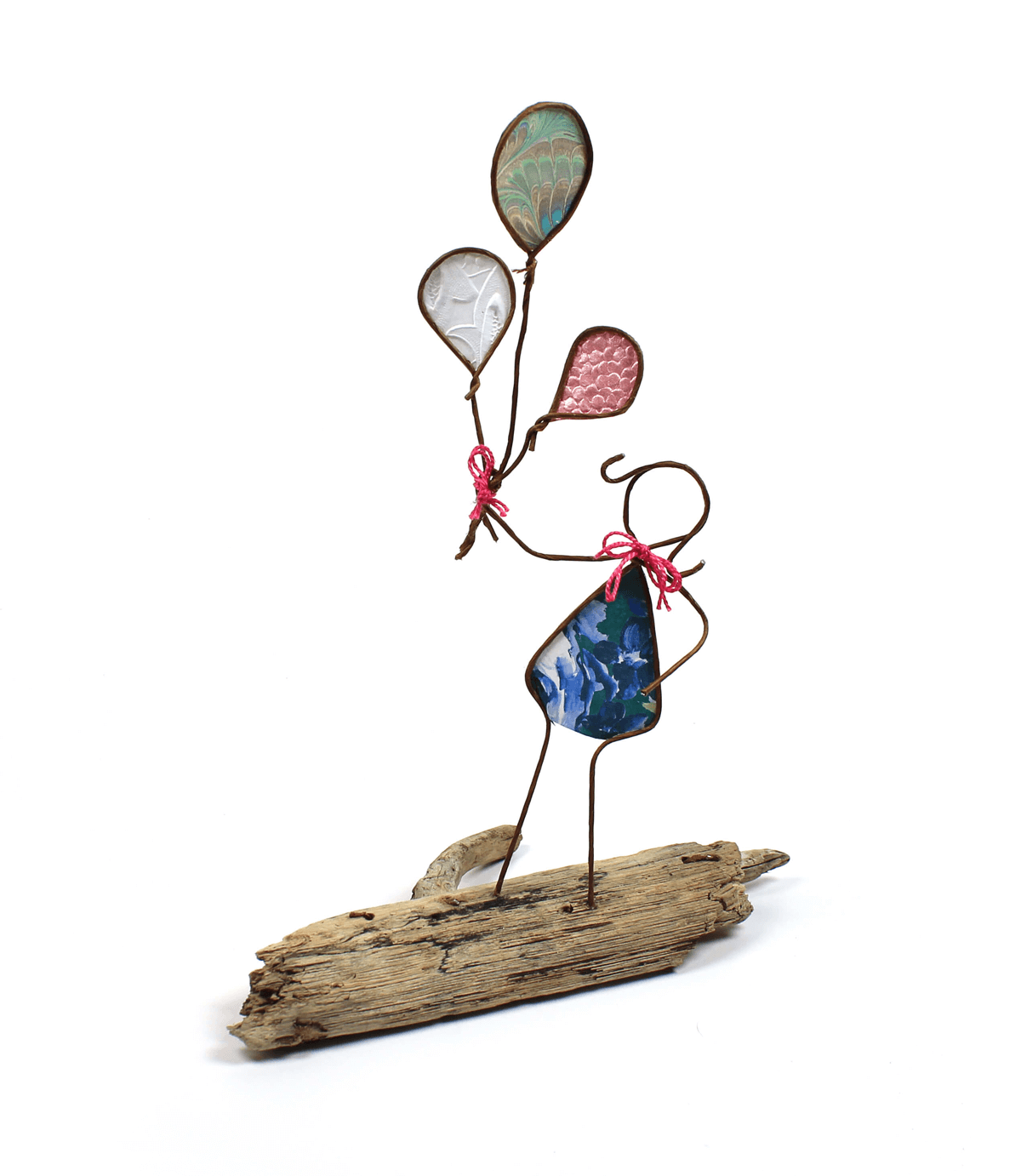 Image of Girl with Balloons, a sculpture in wire and cut paper on driftwood.